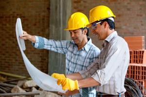 contractors look over deck building plans