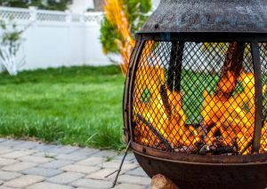 metal firepit or chiminea with an active flame