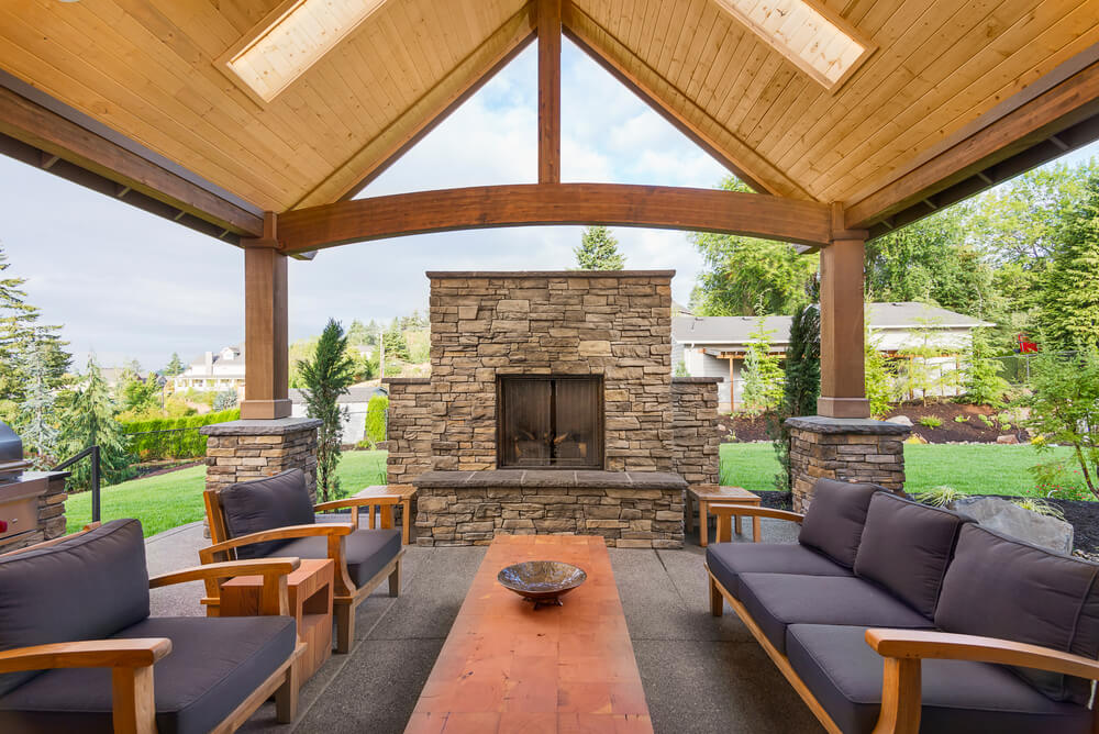 Wide covered patio with outdoor fireplace