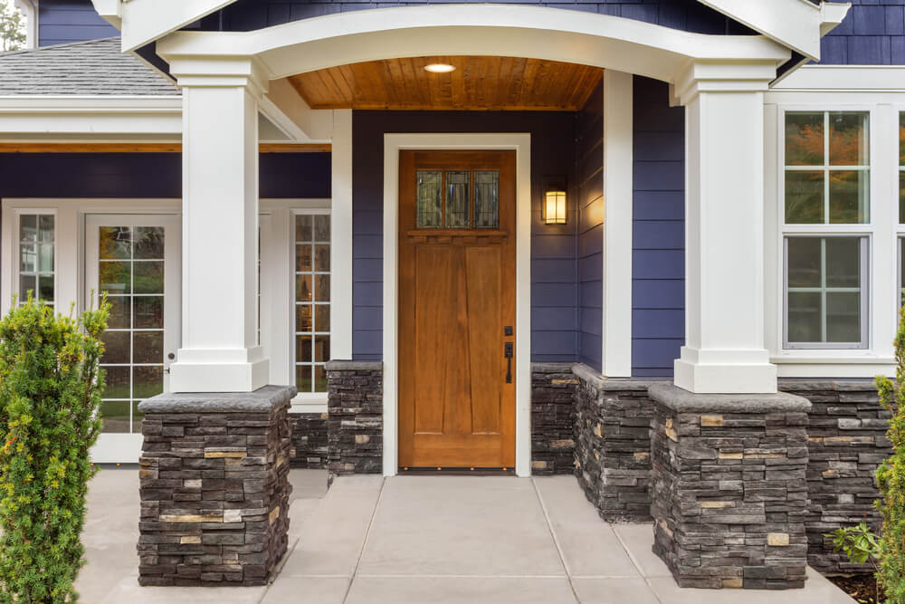 Stone veneer added to white portico porch posts