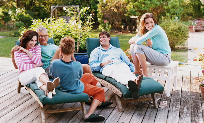 Family sitting on deck together