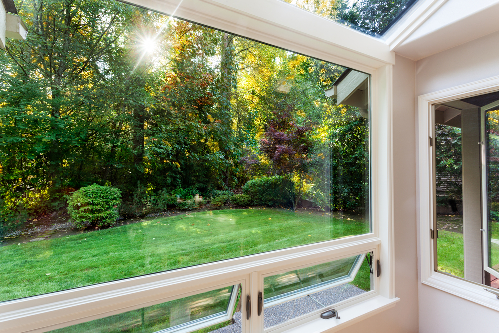 Three season room looking out into green trees and grass in Fairfax