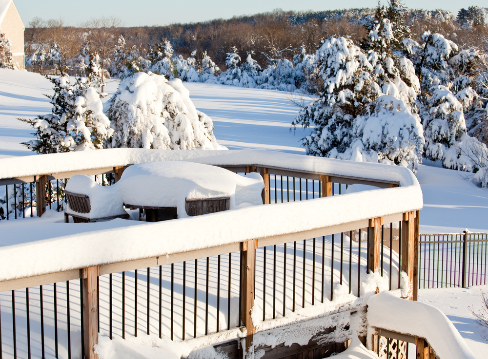 Backyard Deck covered in snow after a blizzard. 