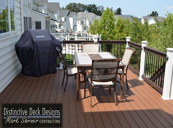 A Virginia backyard with a spacious deck and a table set.