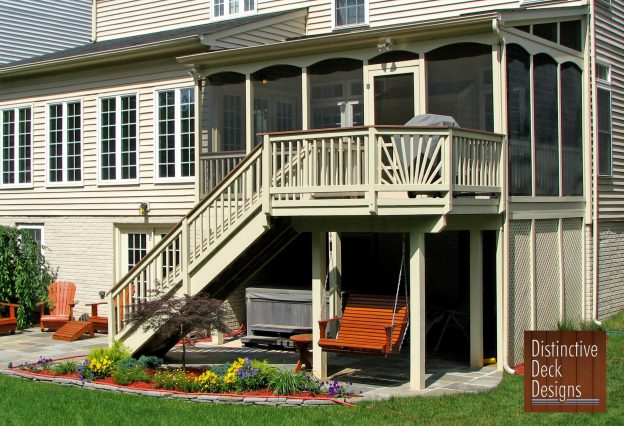 Distinctive Deck Designs two-story deck with a bench swing.